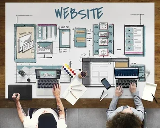 Team working on website design and wireframes with laptops and sketches – web design services in Toronto, Ontario
